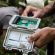 Scientists prepare a bioacoustic monitor for deployment in Indonesia.